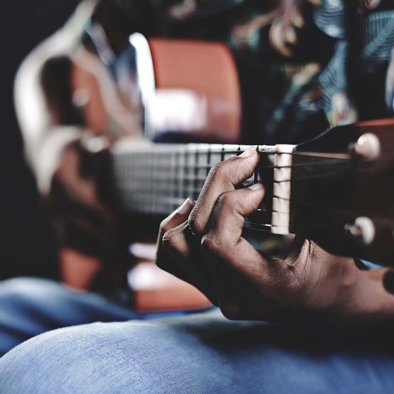 Image of a person playing guitar
