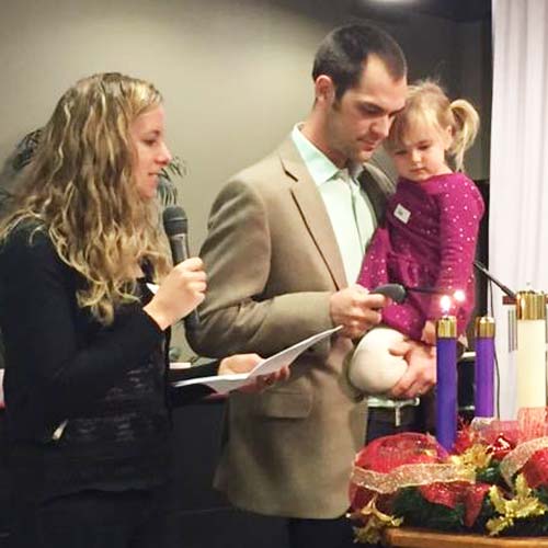 Image of the Pinches family lighting an Advent wreath